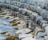 Curving breakwall of stacked stones.