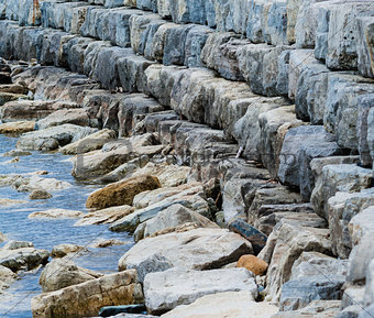 Curving breakwall of stacked stones.