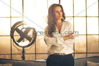 Portrait of thoughtful elegant young woman in loft apartment
