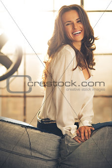 Portrait of smiling young woman in loft apartment