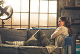 Young woman sitting in loft apartment