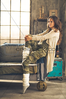 Full length portrait of young woman in loft apartment