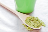 Powdered green tea with wooden spoon 