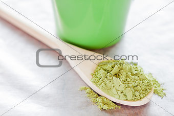 Powdered green tea with wooden spoon 