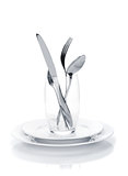 Silverware or flatware set in glass over plates