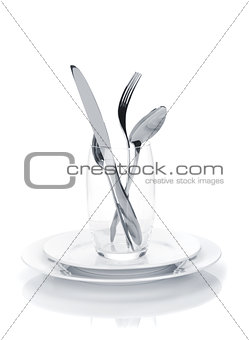 Silverware or flatware set in glass over plates