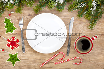 Empty plate, coffee cup and christmas decor