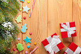Christmas wooden background with snow fir tree, gingerbread cook