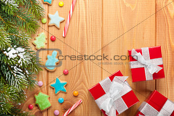 Christmas wooden background with snow fir tree, gingerbread cook