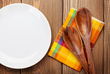 Wood kitchen utensils and empty plate
