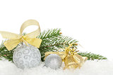 Christmas baubles and golden ribbon with snow fir tree
