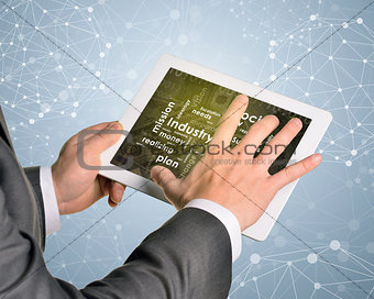 Man hands using tablet pc. Money and business words on touch screen