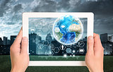 Man hands using tablet pc. Earth and hexagons with icons on touch screen