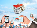 Hands holding smart phones and shoot video as falling house