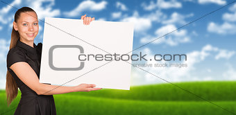 Businesswoman holding empty paper. Blured nature landscape