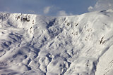 View on off-piste snowy slope at evening
