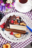 Piece of chocolate cake with cream and fresh fruit