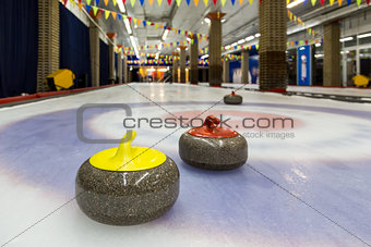Curling stones on an indoor rink