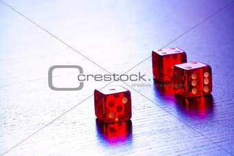 three red dice on old wood black table with space for text