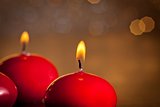 red christmas candles on golden bokeh background
