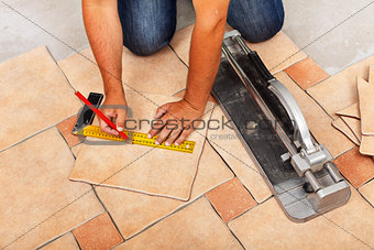Phases of installing ceramic floor tiles - cutting the pieces