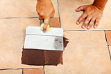 Phases of laying ceramic floor tiles - apply the joint material