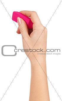 female hand holding a pink eraser to erase on a white background