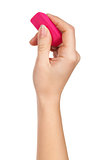 female hand holding a pink eraser to erase on a white background