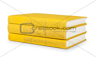 stack of vintage books in a yellow cover on a white background