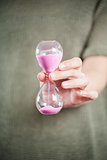 pink sand clock in hand