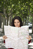 smiling woman watching a map