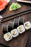 Sushi rolls with eel, cucumber and sesame seed