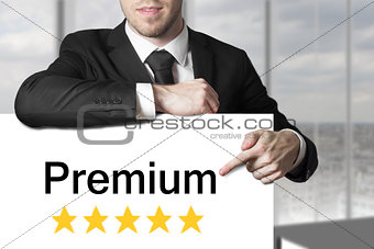 businessman in black suit pointing on sign premium