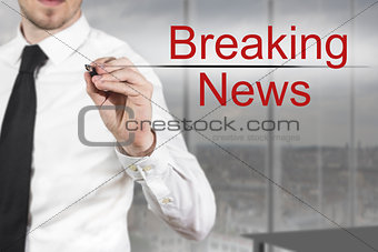 businessman writing breaking news in the air