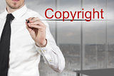 businessman writing copyright in the air