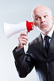 man using a megaphone with ears instead of mouth