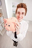 wide angle of a clerk with a piggy bank