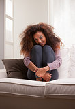 beautiful african-american woman lying on a sofa