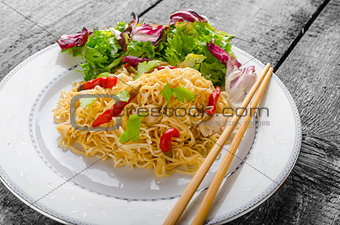 Chinese noodles with chicken and fresh salad