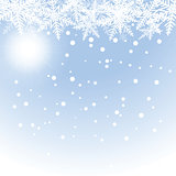 Christmas snowflakes and sun on blue background.