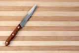 Kitchen knife on wooden board