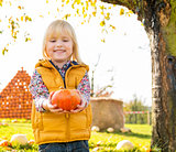 Portrait of happy child with pumpkin