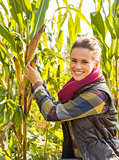 Portrait of happy young woman tearing corn