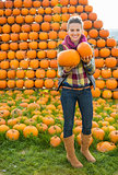 Portrait of happy young woman with pumpkins