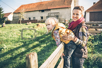 Portrait of happy mother and child on farm