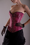 Beautiful young woman in pink corset 