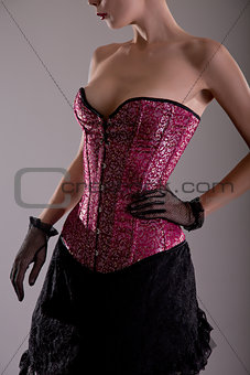 Beautiful young woman in pink corset 