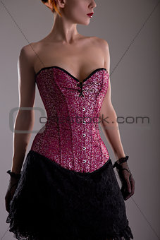 Attractive young woman in purple corset 
