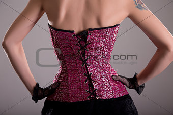 Rear view of elegant woman wearing purple corset 