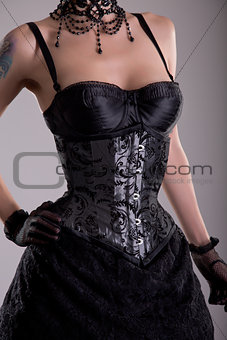 Close-up shot of beautiful young woman in silver corset  